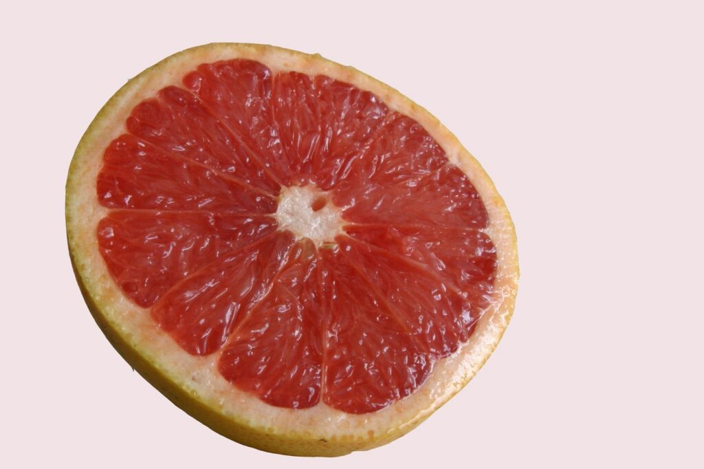 Sliced grapefruit on a light background.