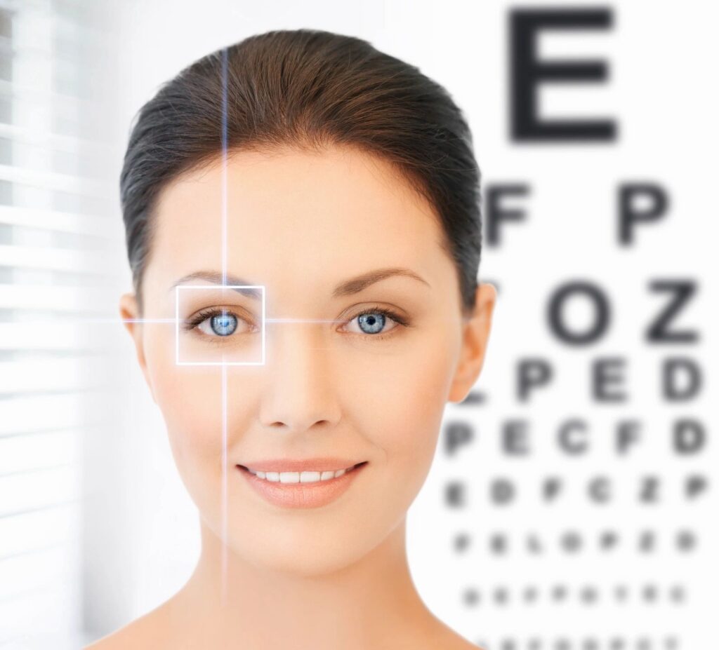 Woman smiling near eye chart.