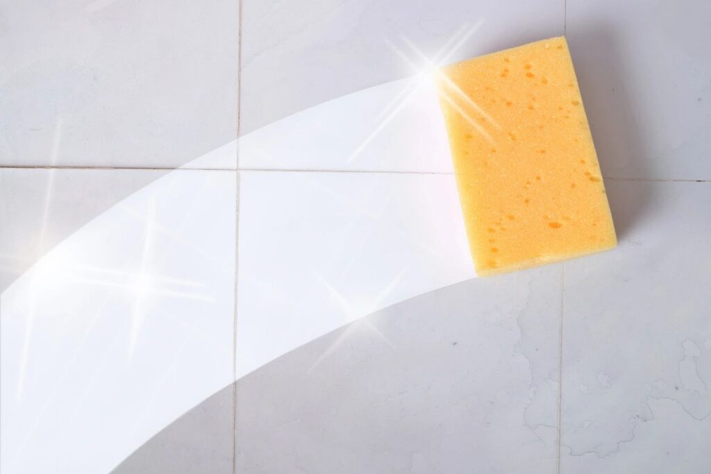 Sponge cleaning a tiled surface with shine.