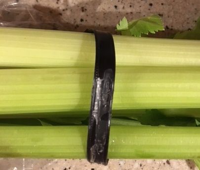 Celery stalks bundled with black band.
