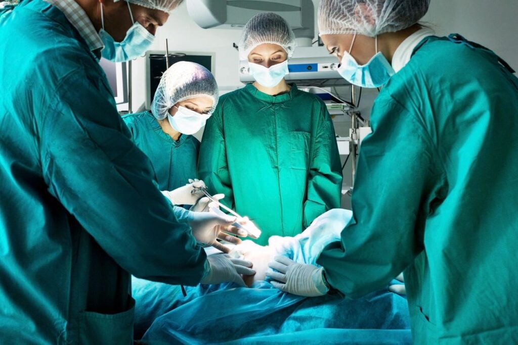 Surgeons performing operation in operating room.