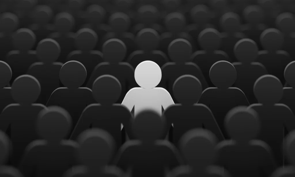 Person standing out from the crowd of people, with a black and white background
