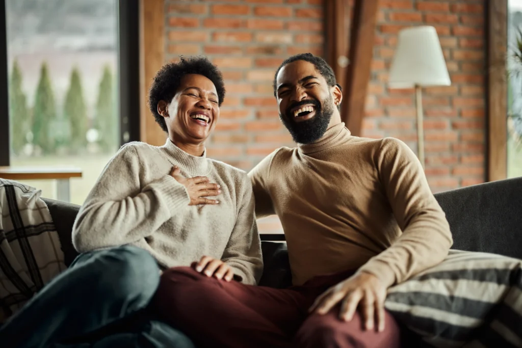 Man and woman sitting on a couch, at each other