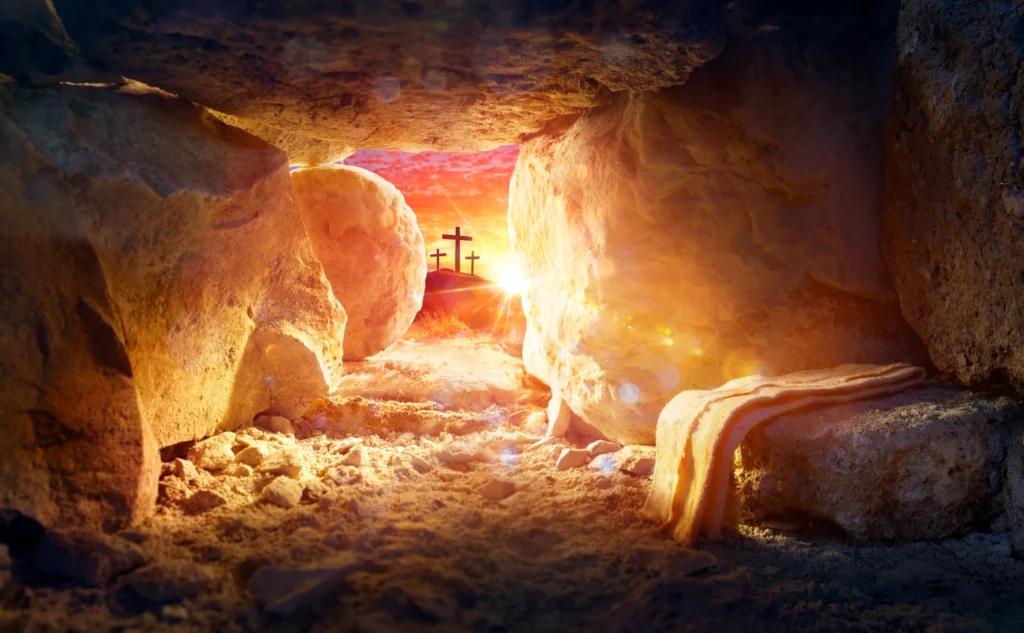 Cave with a cross in the middle of it, illuminated by the light of the sun