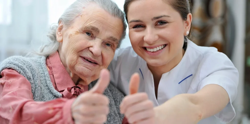 Woman giving a thumbs up to a nurse, with a blurred background