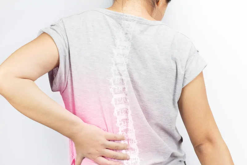 Woman standing with her back to the camera, wearing a t-shirt with a white background