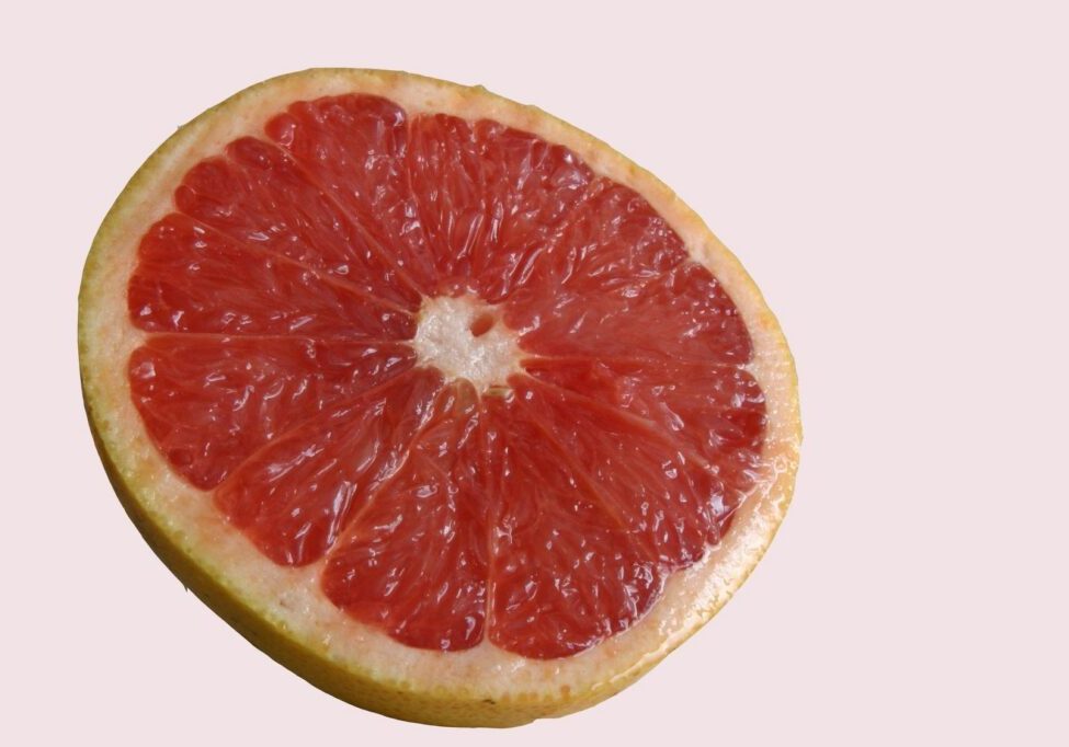 Sliced grapefruit on a light background.