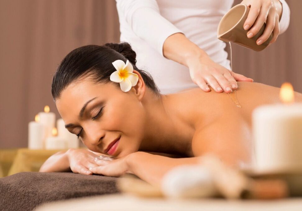 Woman enjoying relaxing spa massage session.