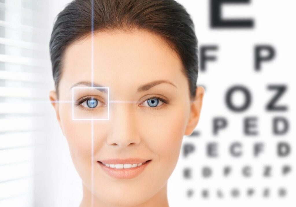 Woman smiling near eye chart.