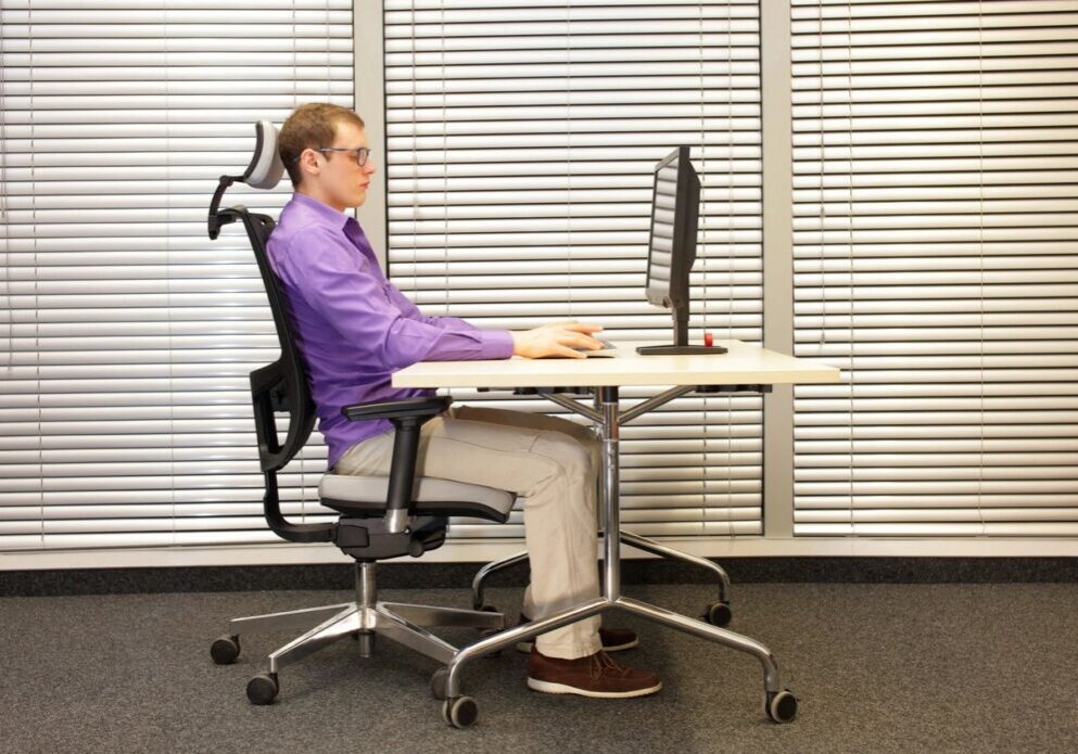 Man sitting at desk using computer.