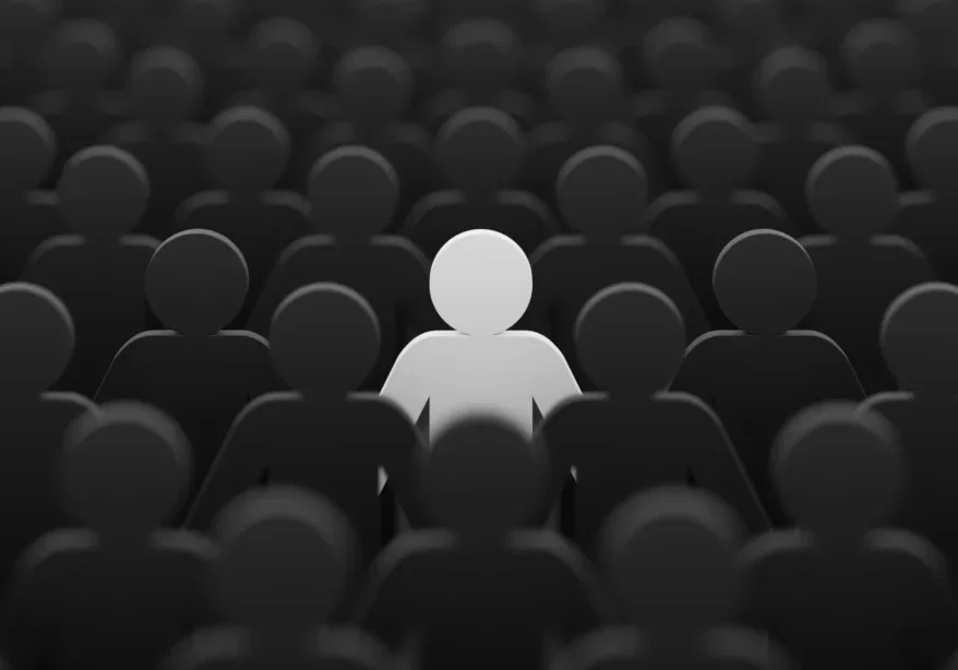 Person standing out from the crowd of people, with a black and white background