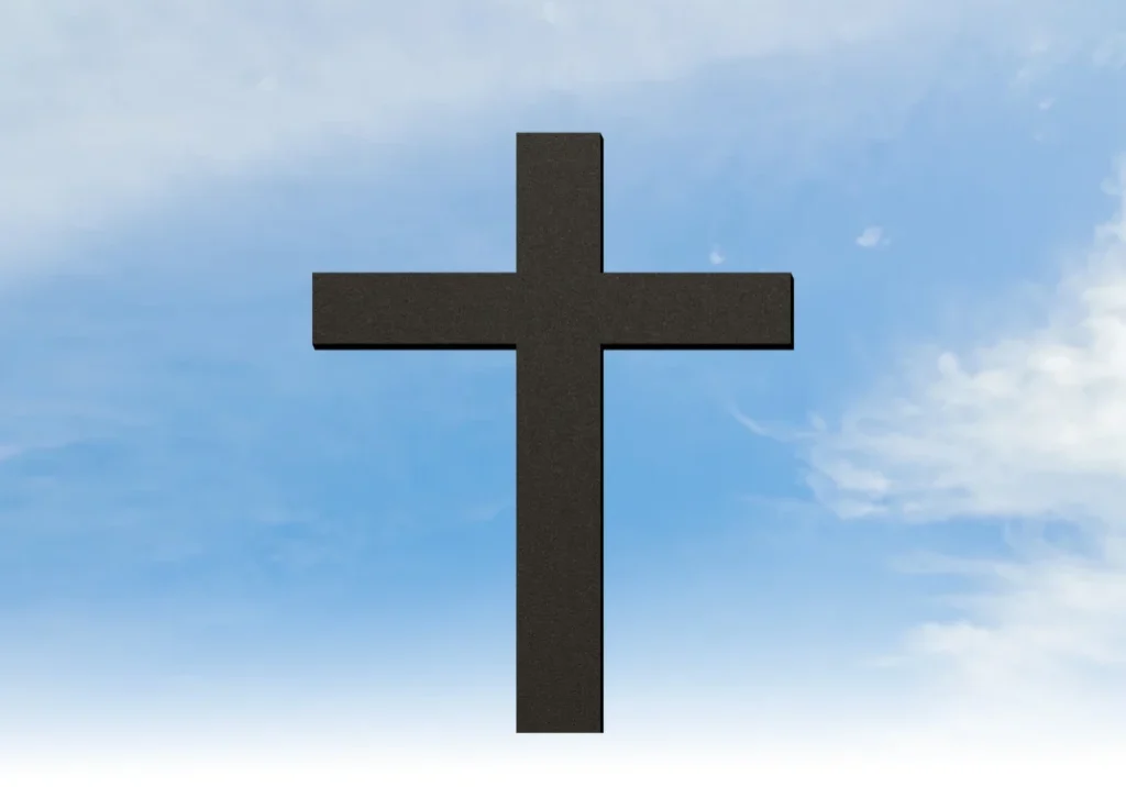 Black cross against a blue sky with white clouds, creating a peaceful and serene atmosphere
