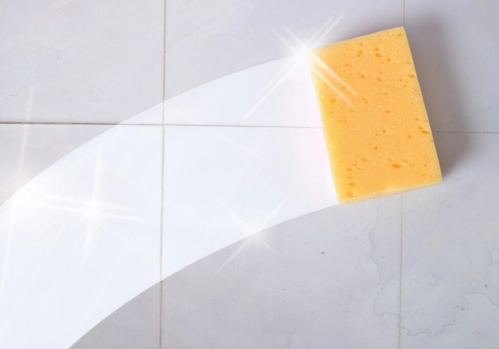 Sponge cleaning a tiled surface with shine.