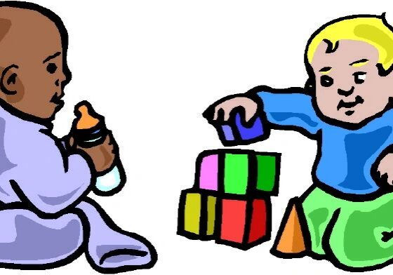 Babies playing with blocks and bottle.