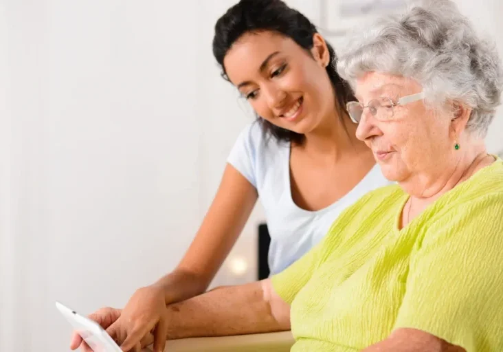 Elderly woman and young caregiver