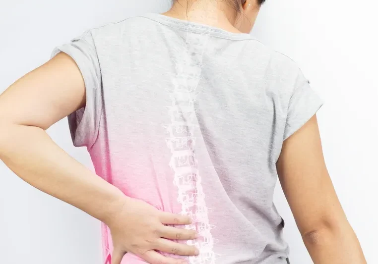 Woman standing with her back to the camera, wearing a t-shirt with a white background