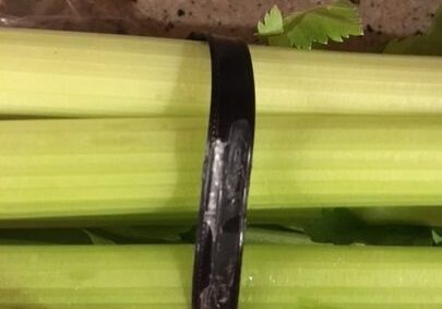 Celery stalks bundled with black band.