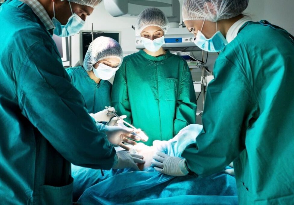 Surgeons performing operation in operating room.