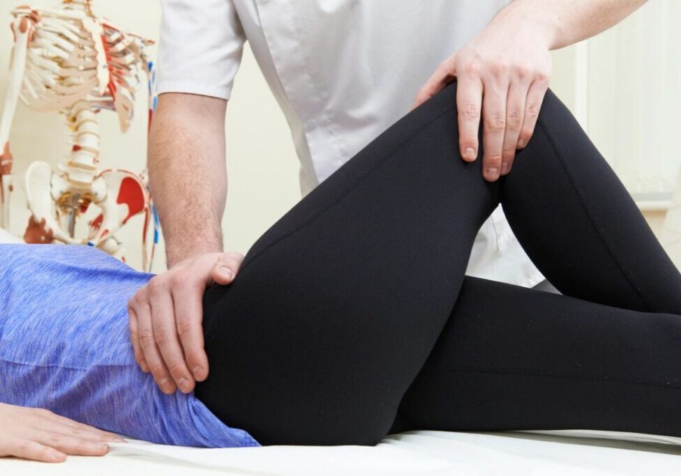 Physical therapy session with patient on table.